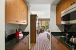 The kitchenette is equipped with a stove-top, microwave, dishwasher and refrigerator for your convenience